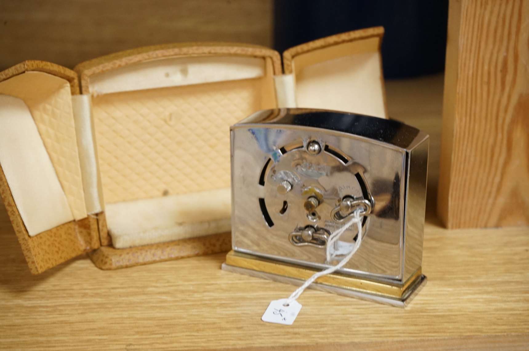 Two Art Deco timepieces comprising a Japy alarm clock and a Jas cased travelling example, largest 22cm wide